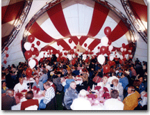 Inside a red and white Arabesque Quartet Tent at a special event with tables