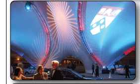 Arabesque Triad with theatrical lighting projection at night